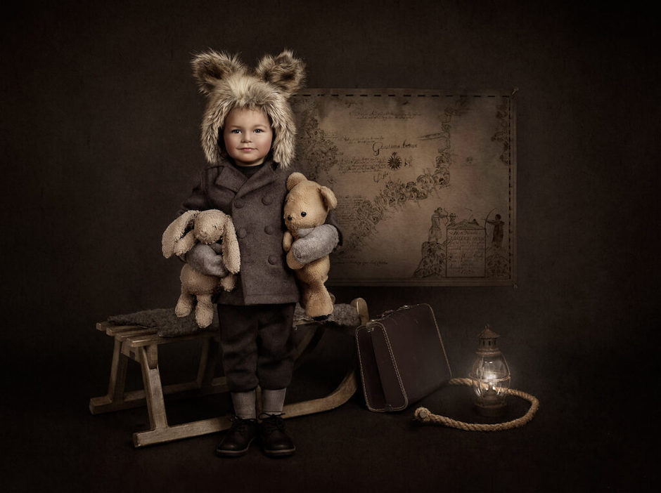 Portrait Masters winner of little boy with fur hat and stuffed animals.